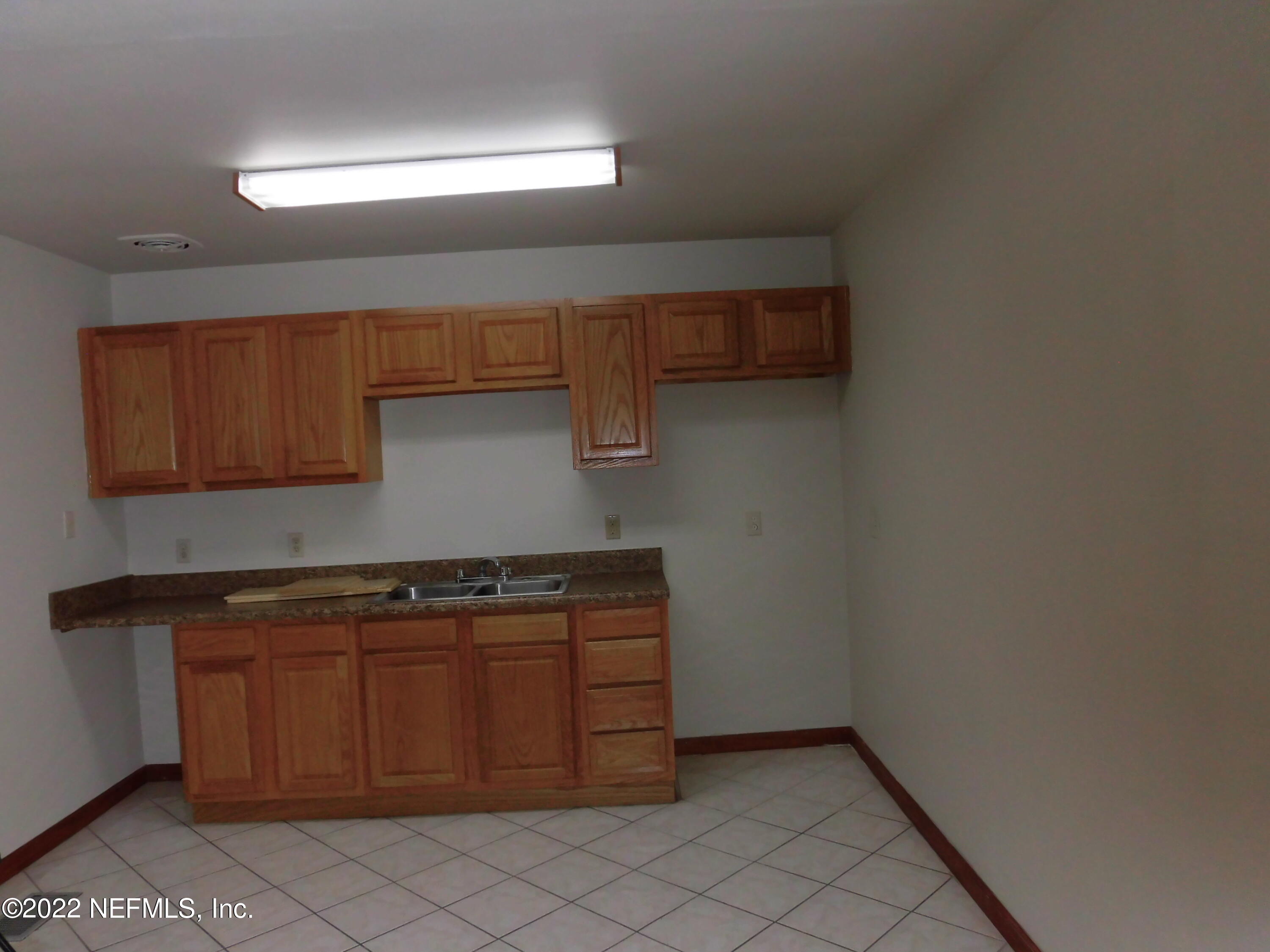 1750 Rogero Road Jacksonville, FL 32211 - Photo 12 of 35 a kitchen with a sink and cabinets