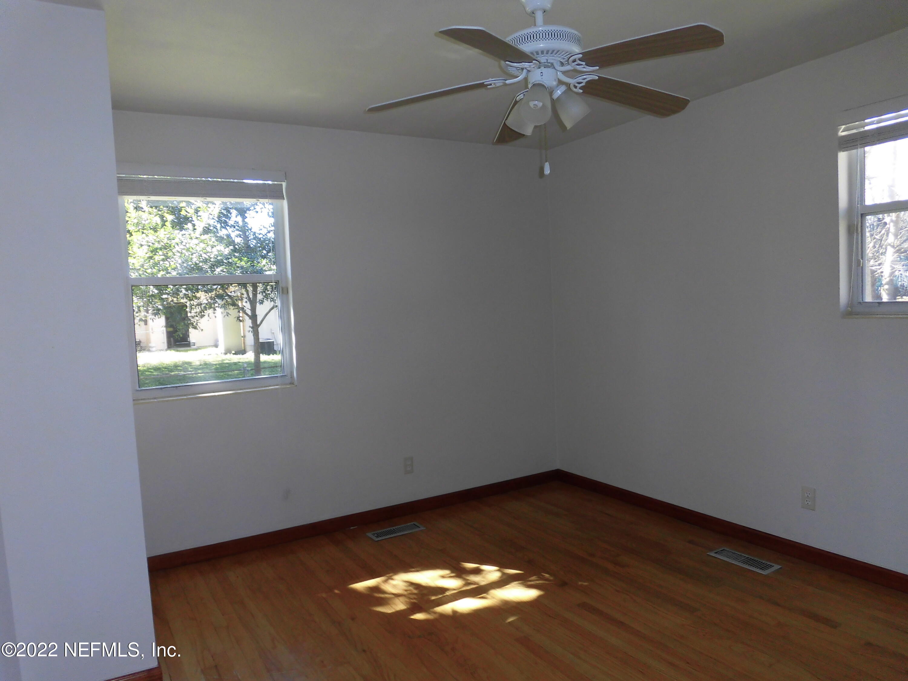 1750 Rogero Road Jacksonville, FL 32211 - Photo 16 of 35 an empty room with a window and wooden floor