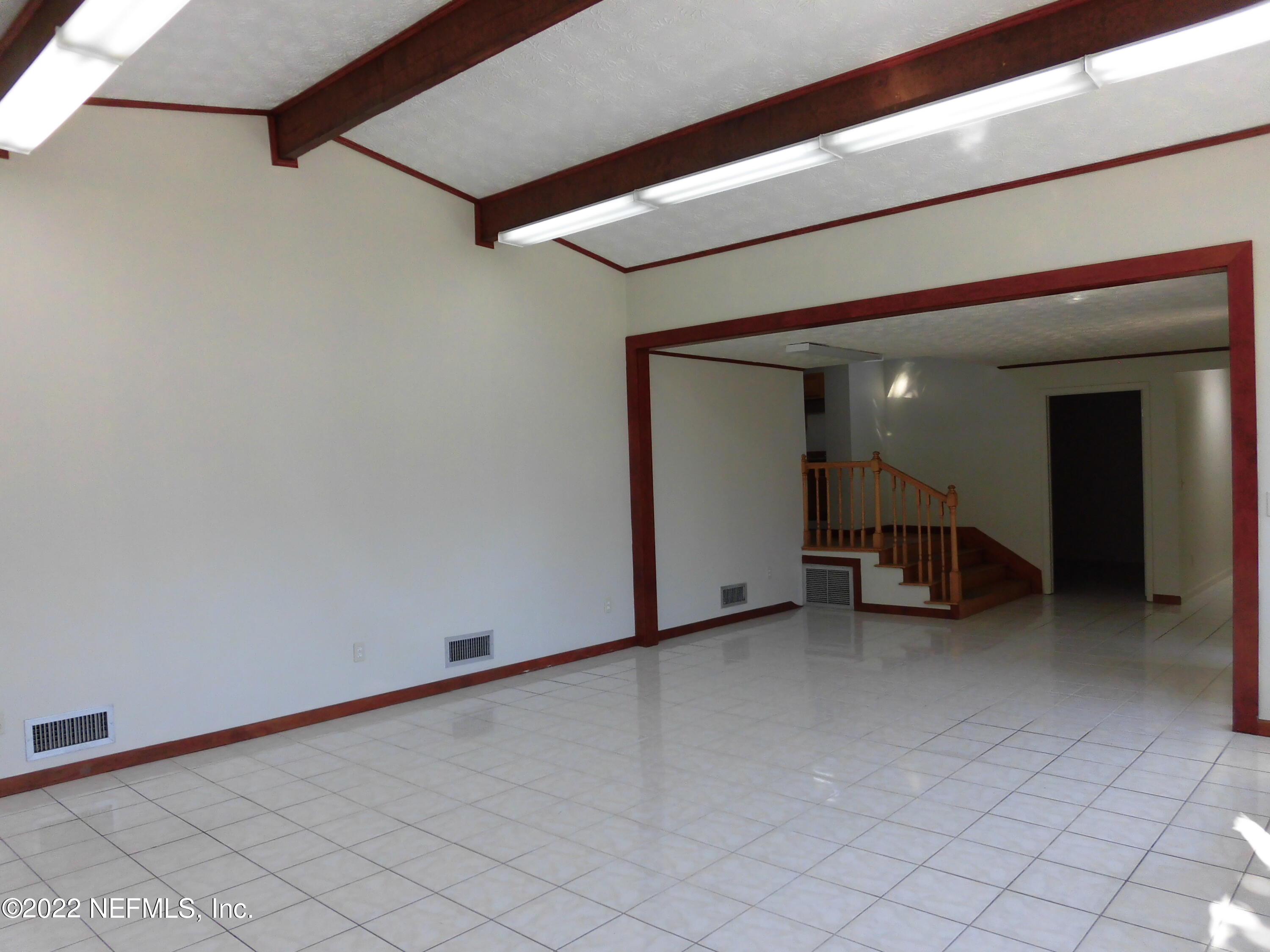 1750 Rogero Road Jacksonville, FL 32211 - Photo 32 of 35 a view of empty room with wooden walls