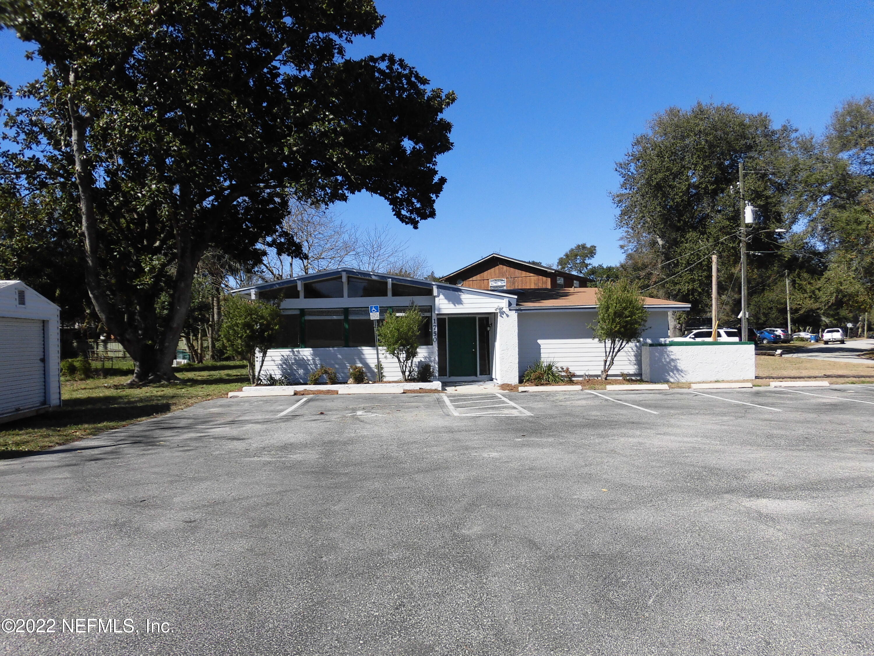 1750 Rogero Road Jacksonville, FL 32211 - Photo 4 of 35 a view of a house with a yard and tree s