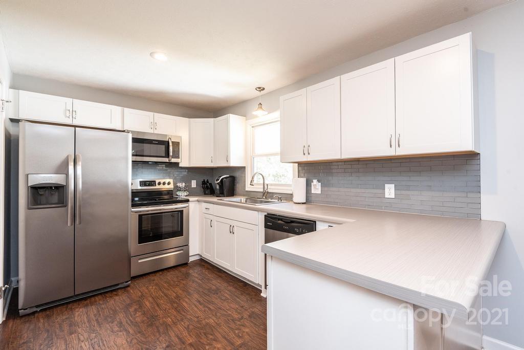 5196 Jenkins Road Morganton, NC 28655 - Photo 18 of 46 a kitchen with a refrigerator sink and cabinets