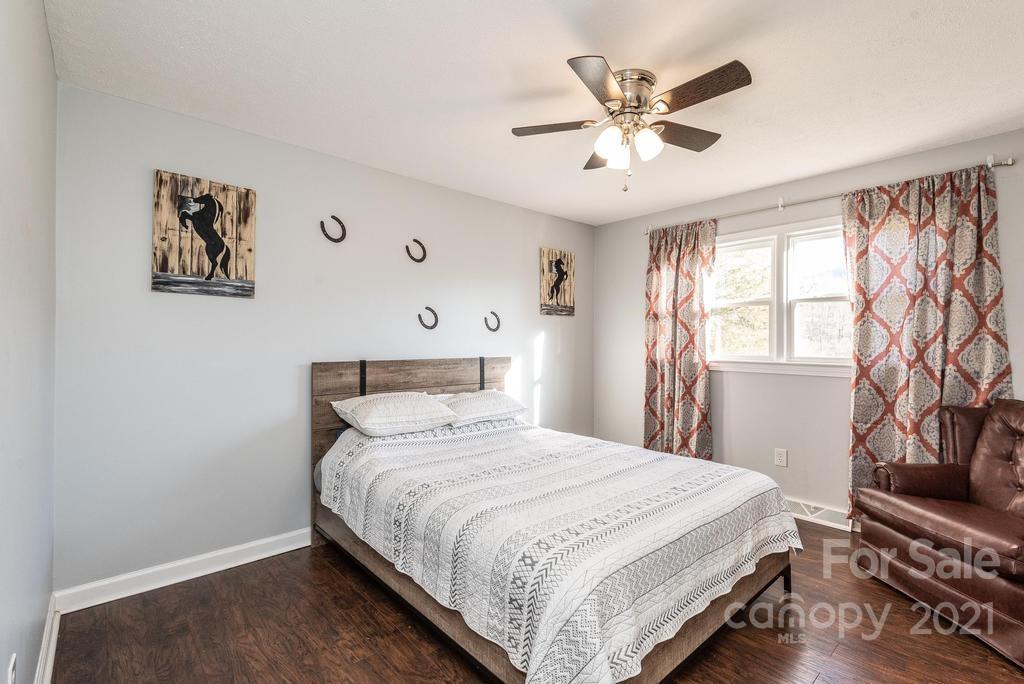 5196 Jenkins Road Morganton, NC 28655 - Photo 26 of 46 a bedroom with a large bed and a ceiling fan