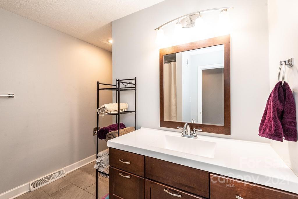 5196 Jenkins Road Morganton, NC 28655 - Photo 28 of 46 a bathroom with a sink and a mirror