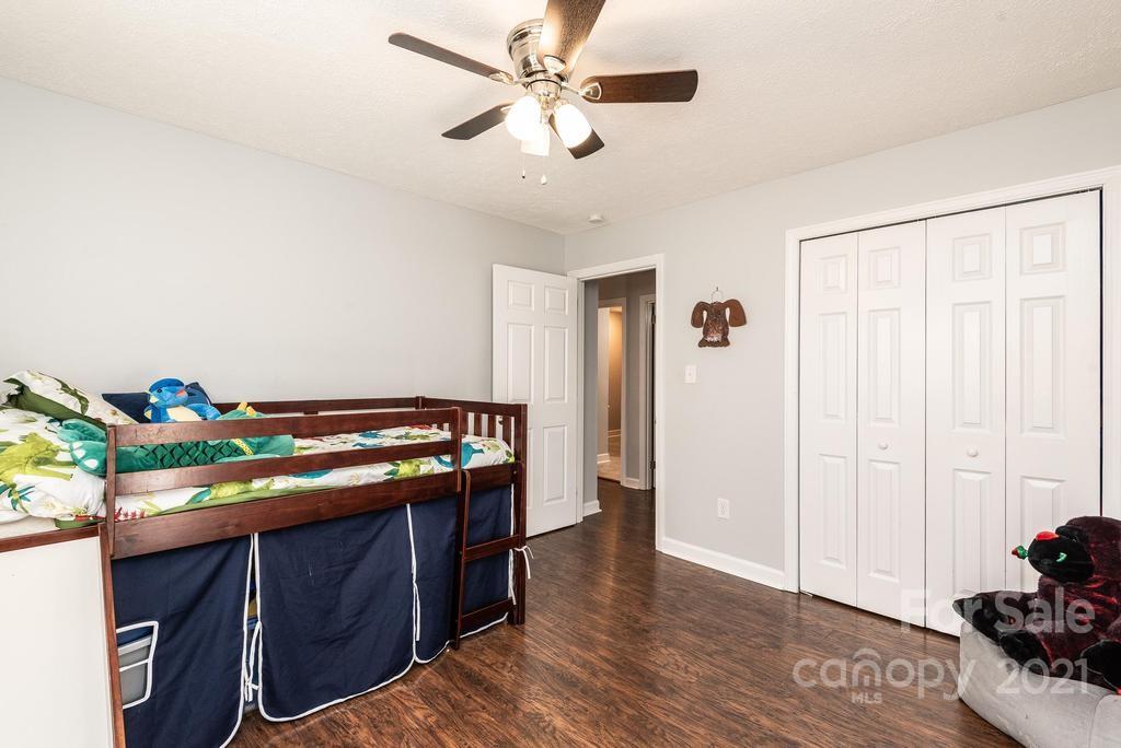 5196 Jenkins Road Morganton, NC 28655 - Photo 30 of 46 a room with furniture and a chandelier fan