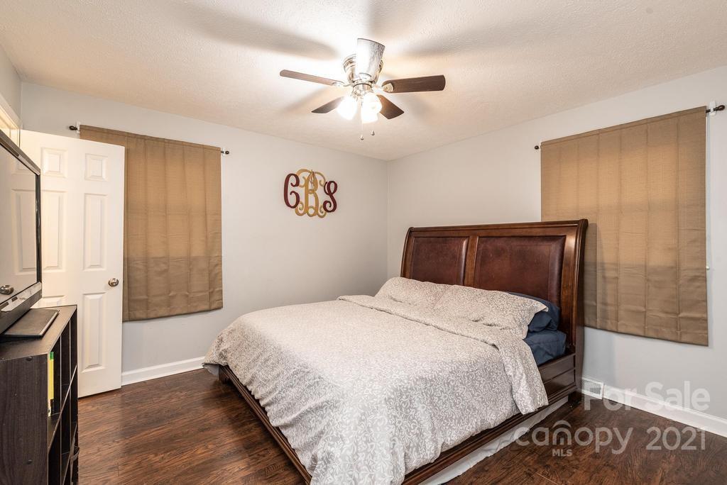 5196 Jenkins Road Morganton, NC 28655 - Photo 31 of 46 a bedroom with a bed and a chandelier