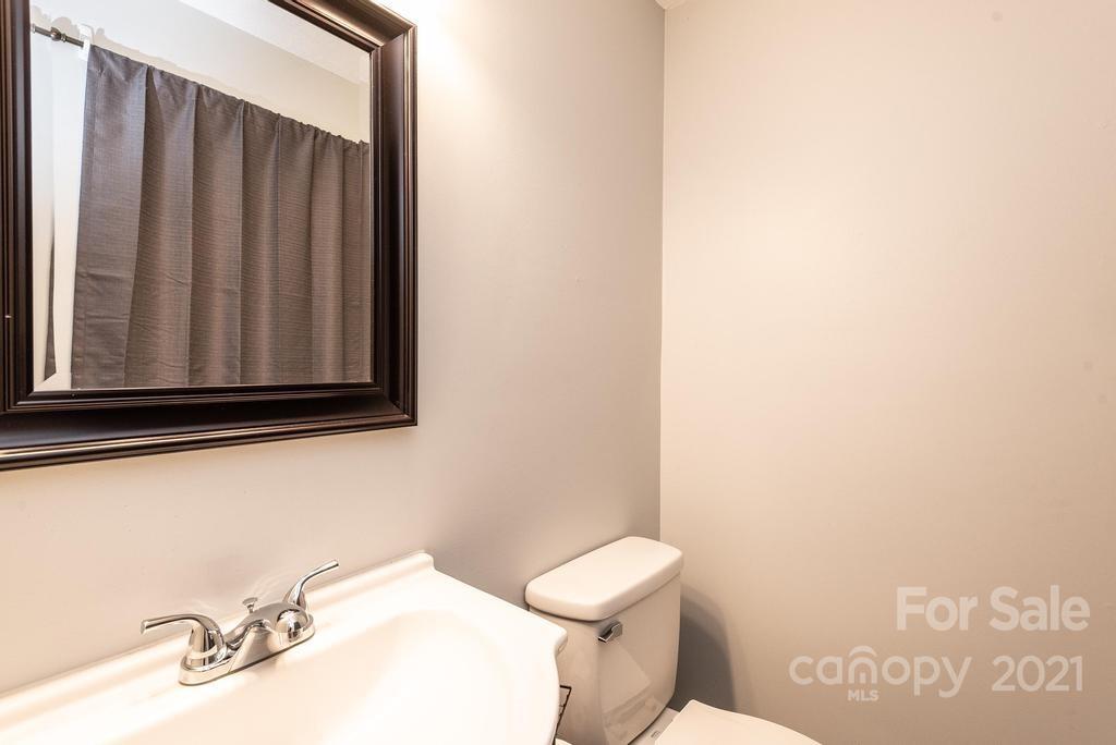 5196 Jenkins Road Morganton, NC 28655 - Photo 33 of 46 a bathroom with a sink a toilet and mirror