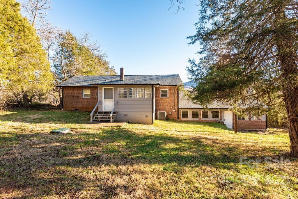 5196 Jenkins Road Morganton, NC 28655 - Photo 5 of 46 a view of a house with a yard and large tree