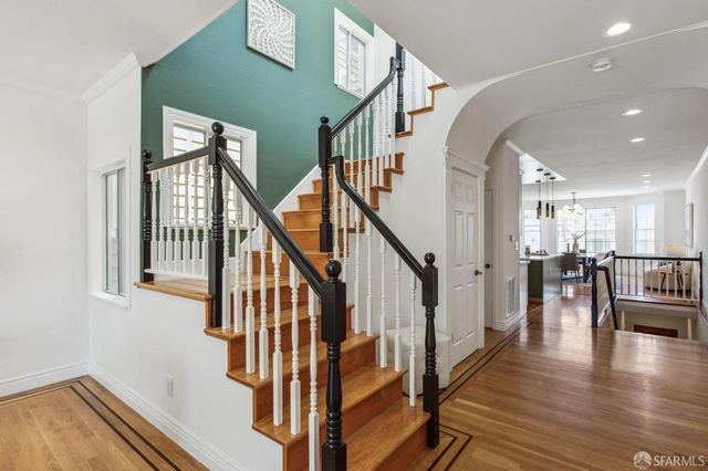 a spacious bedroom with a bed and wooden floor