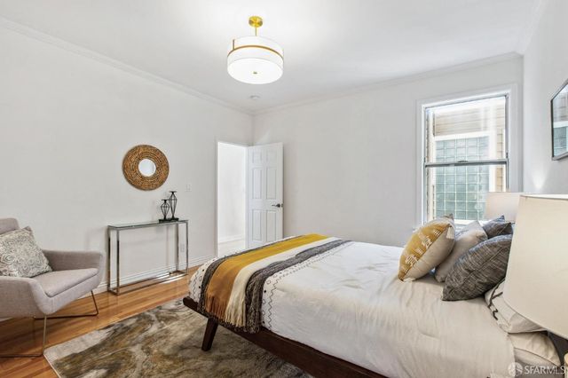 a spacious bedroom with two beds and a potted plant
