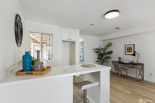 a bathroom with a sink vanity granite toilet and shower