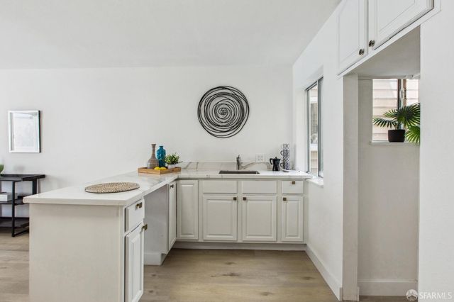 a view of a roof deck with table and chairs and wooden floor