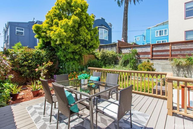 a view of a patio with table and chairs and potted plants