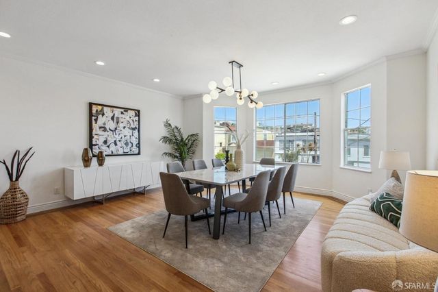 a view of a dining room with furniture window and wooden floor