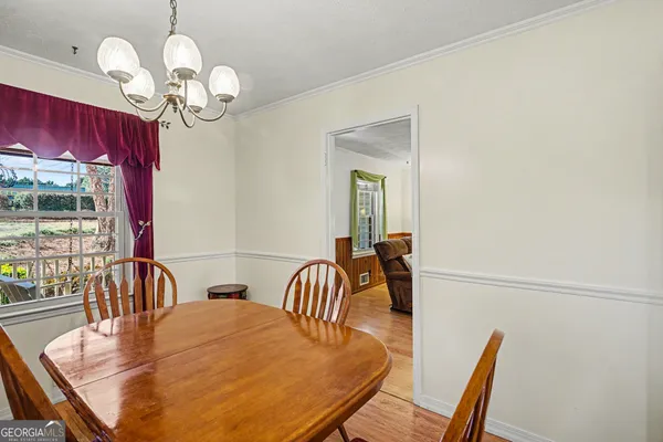 a kitchen with white cabinets and refrigerator