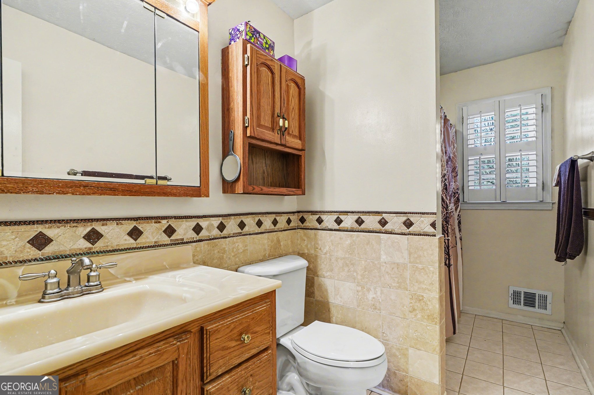 1522 Zebulon Road Griffin, GA 30224 - Photo 16 of 28 a bathroom with a sink a toilet and shower
