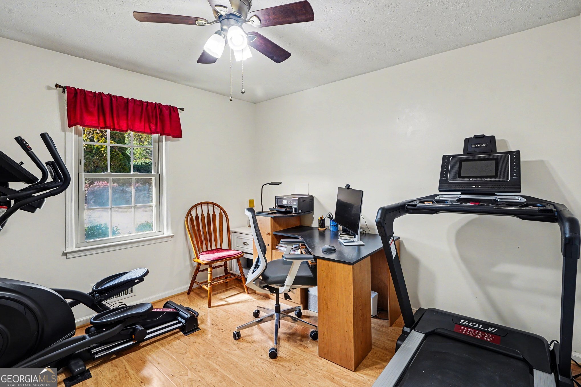 1522 Zebulon Road Griffin, GA 30224 - Photo 17 of 28 a room with gym equipment and windows