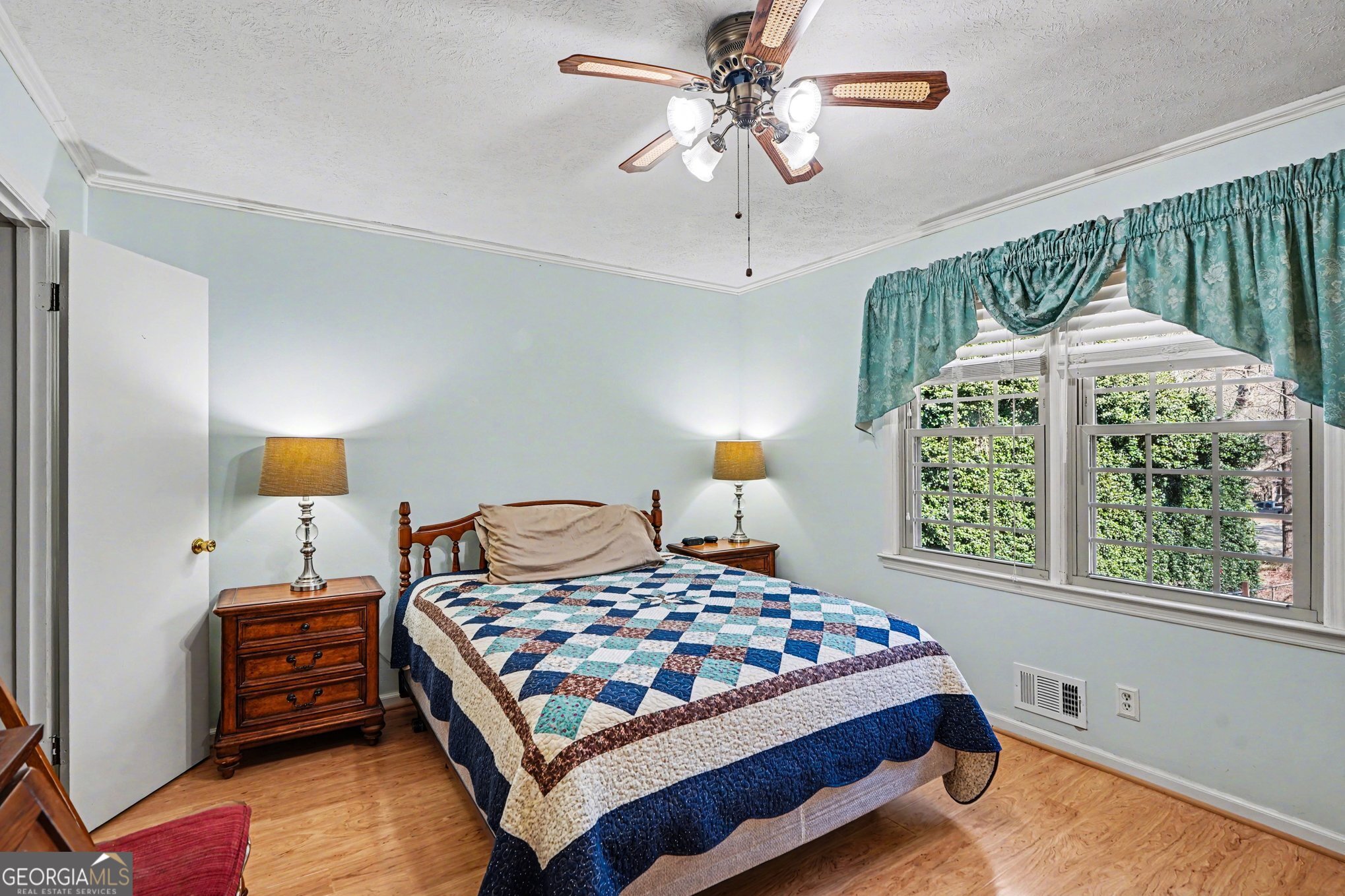 1522 Zebulon Road Griffin, GA 30224 - Photo 18 of 28 a bedroom with a bed a window and a chandelier