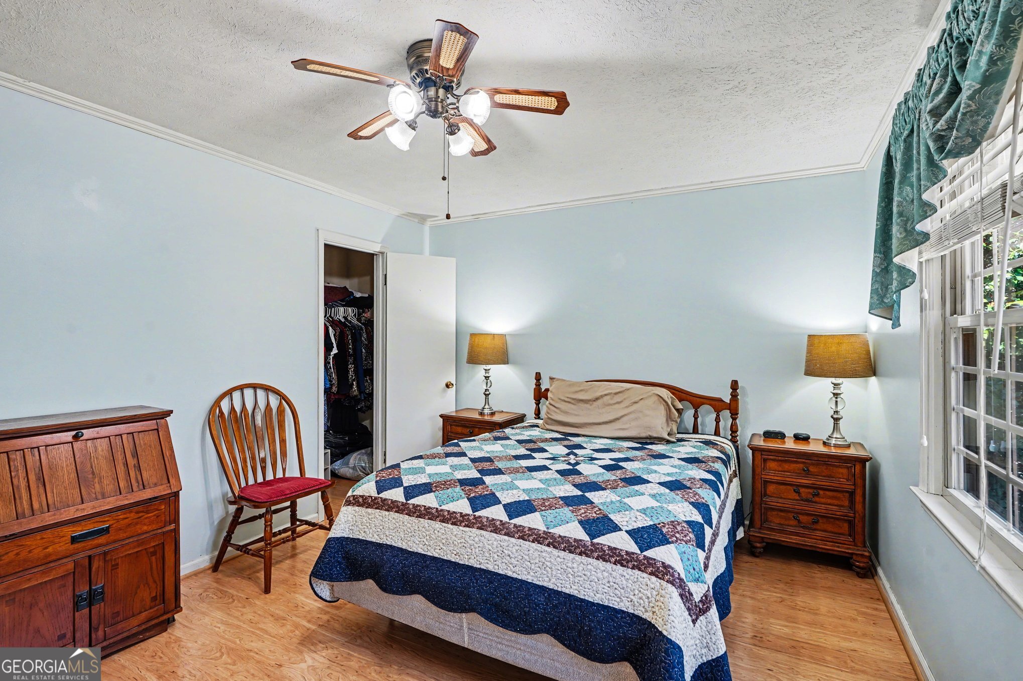 1522 Zebulon Road Griffin, GA 30224 - Photo 20 of 28 a bedroom with a bed and a chandelier