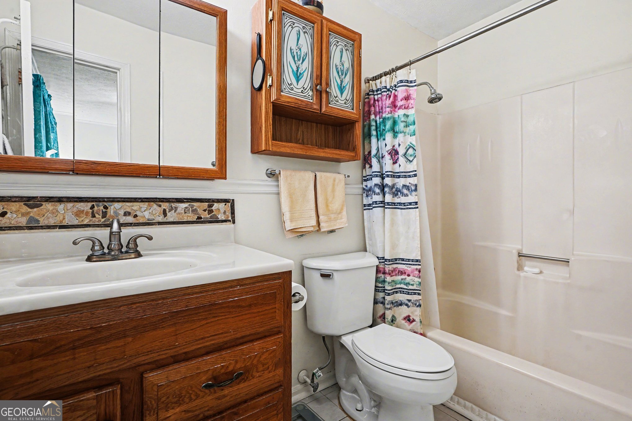 1522 Zebulon Road Griffin, GA 30224 - Photo 21 of 28 a bathroom with a sink a toilet and shower