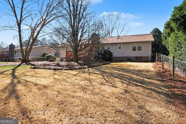 a view of a house with a yard covered in snow