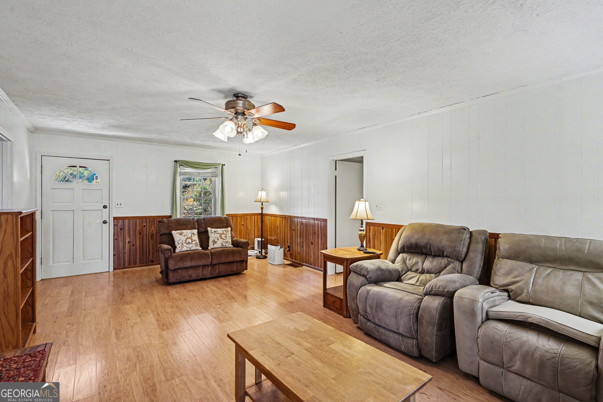 1522 Zebulon Road Griffin, GA 30224 - Photo 8 of 28 a living room with furniture and a wooden floor