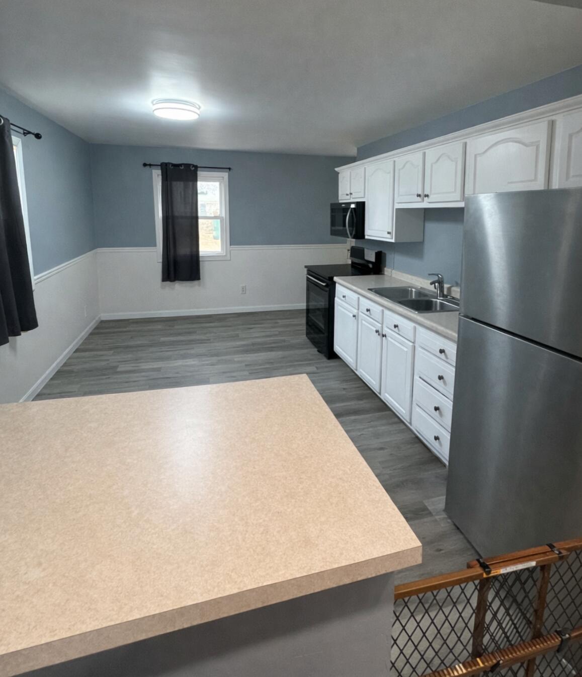 726-1 Imperial Road Valparaiso, IN 46385 - Photo 3 of 8 a kitchen with stainless steel appliances granite countertop a refrigerator a stove and white cabinets with wooden floor
