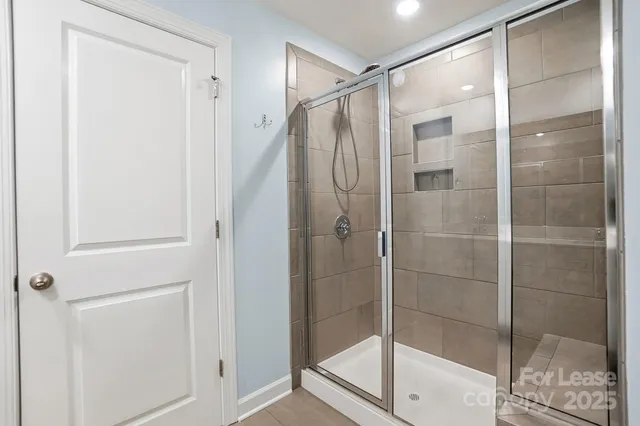 a bathroom with a glass shower door