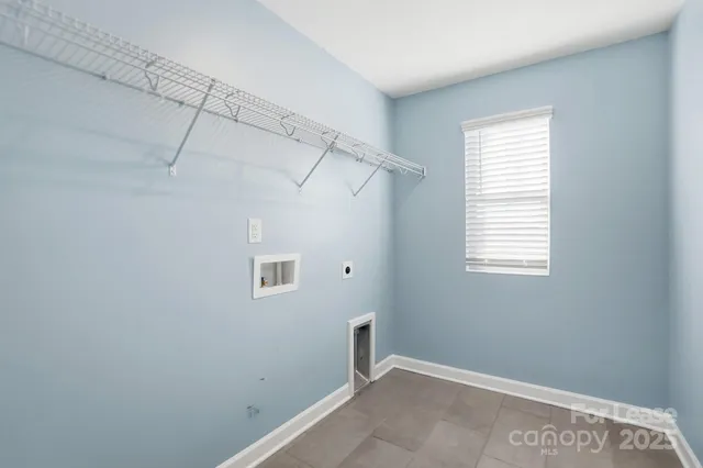 a view of a room that has a window and a fan