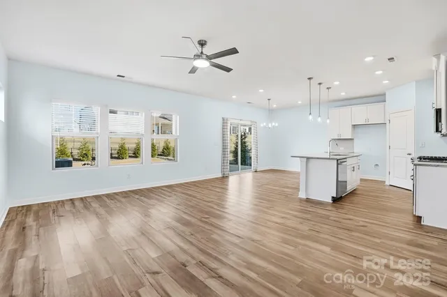 a view of kitchen with cabinets and wooden floor
