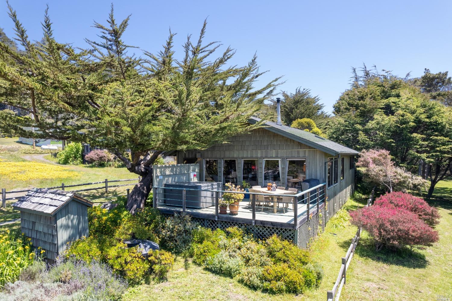 a view of a house with swimming pool and sitting area