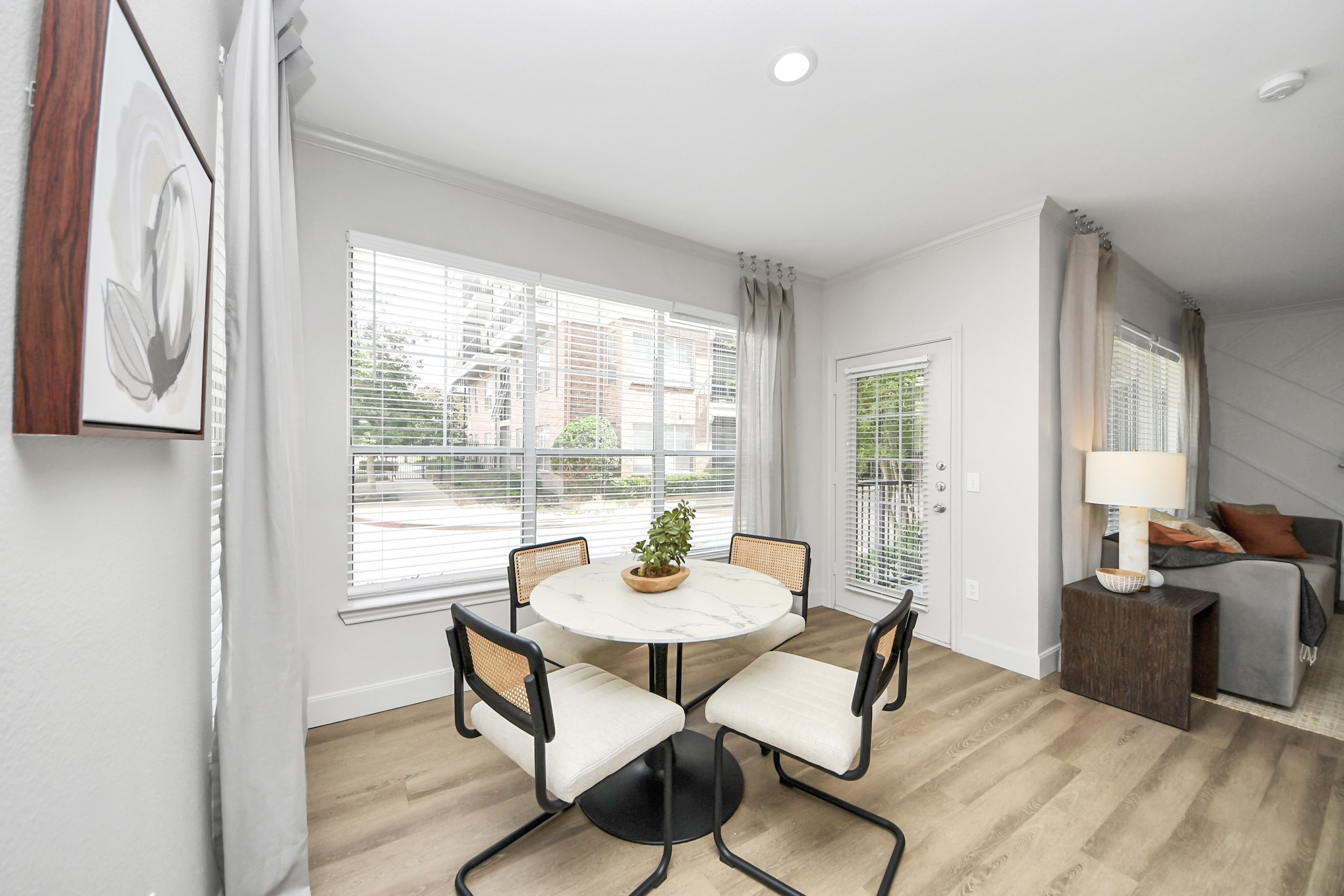 3003 Memorial Court, Unit 2434 Houston, TX 77007 - Photo 24 of 34 a dining room with furniture window wooden floor and kitchen view