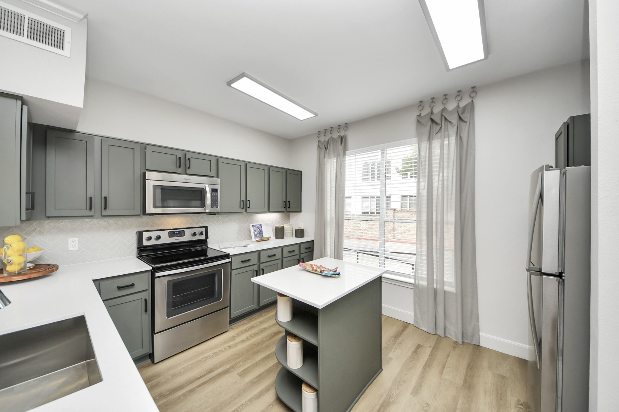 3003 Memorial Court, Unit 2434 Houston, TX 77007 - Photo 26 of 34 a kitchen with stainless steel appliances granite countertop a refrigerator stove microwave and sink