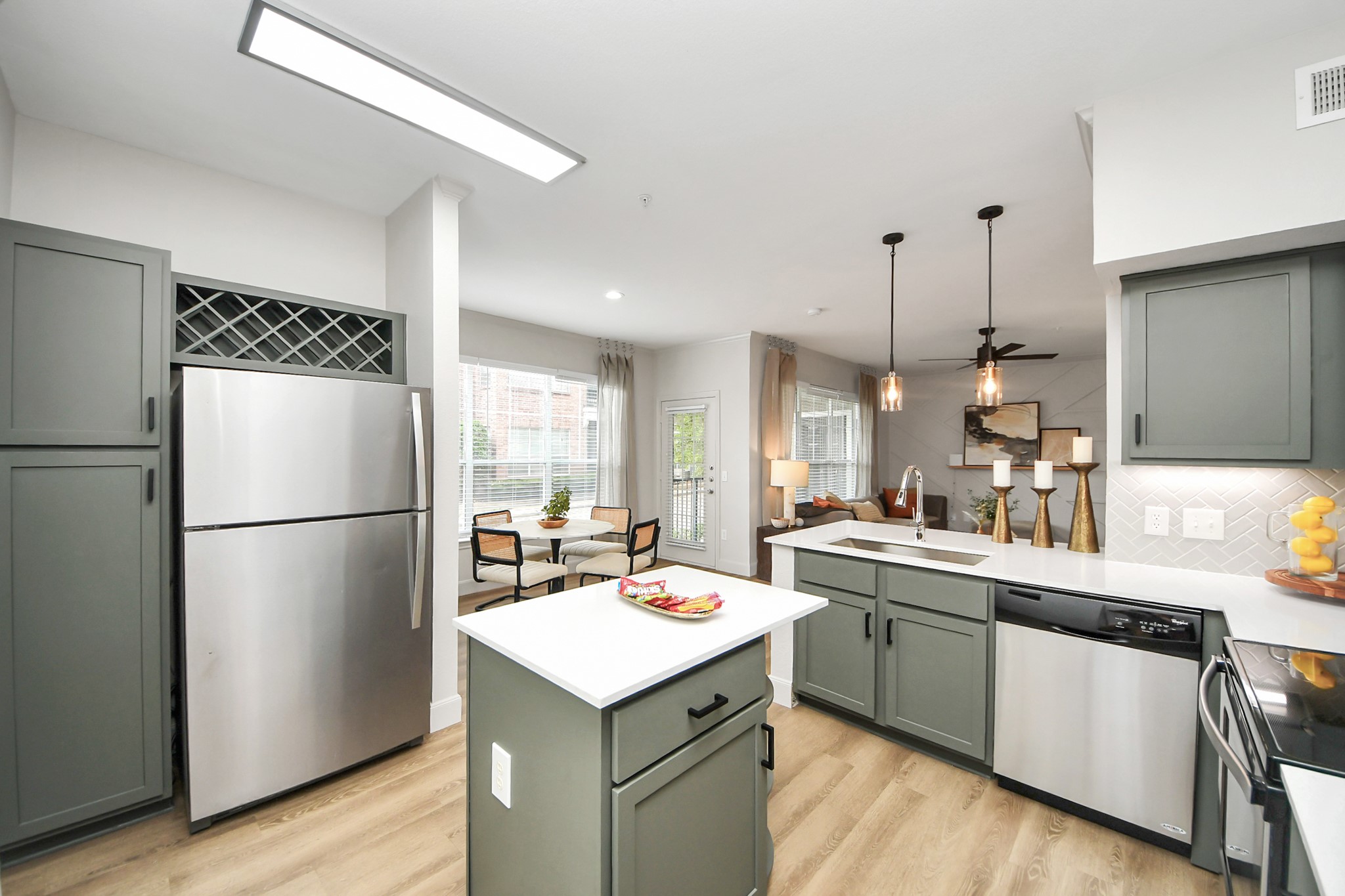 3003 Memorial Court, Unit 2434 Houston, TX 77007 - Photo 27 of 34 a kitchen with a sink a refrigerator and wooden floor