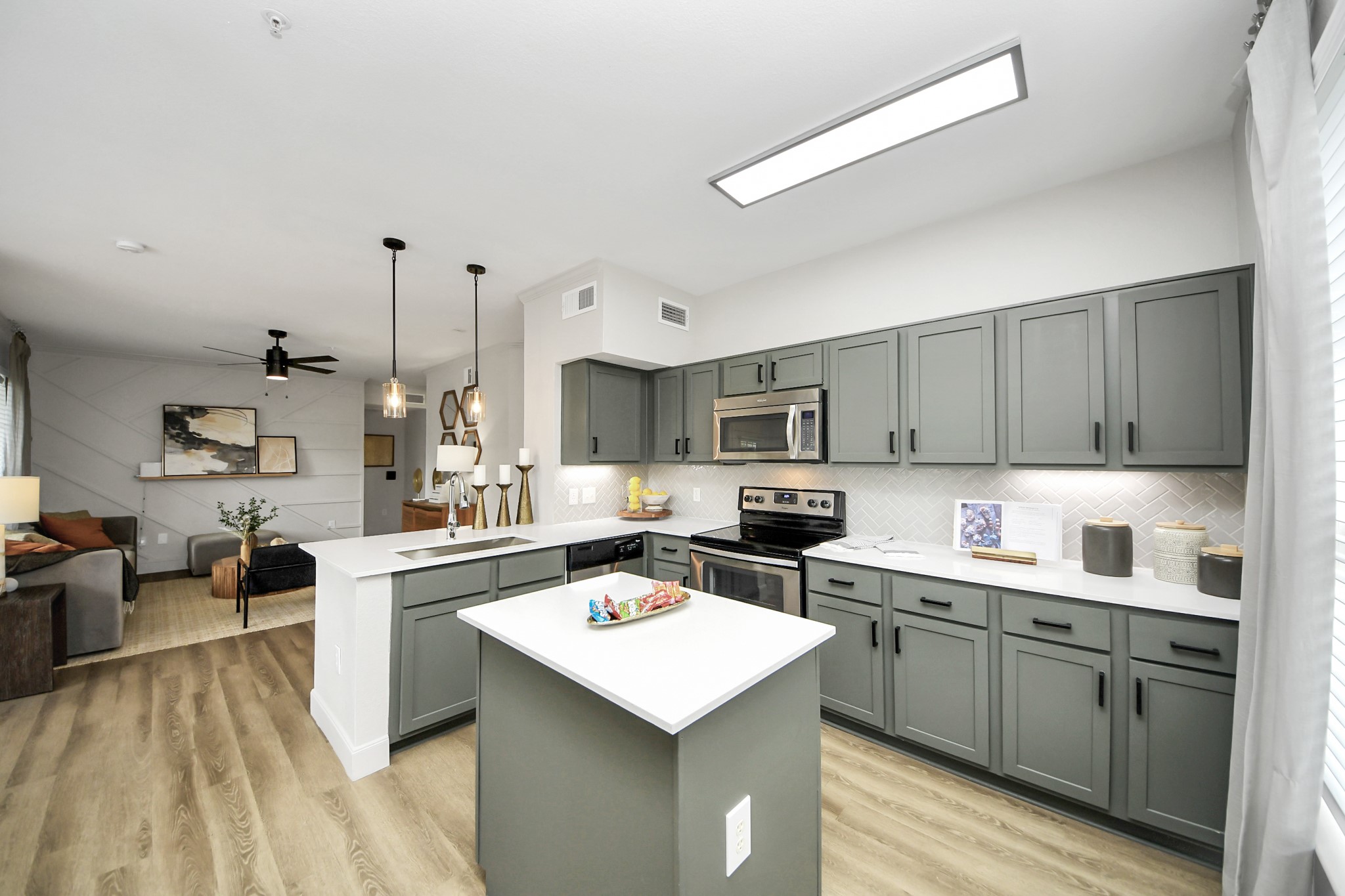 3003 Memorial Court, Unit 2434 Houston, TX 77007 - Photo 12 of 34 a kitchen with a sink a stove and cabinets