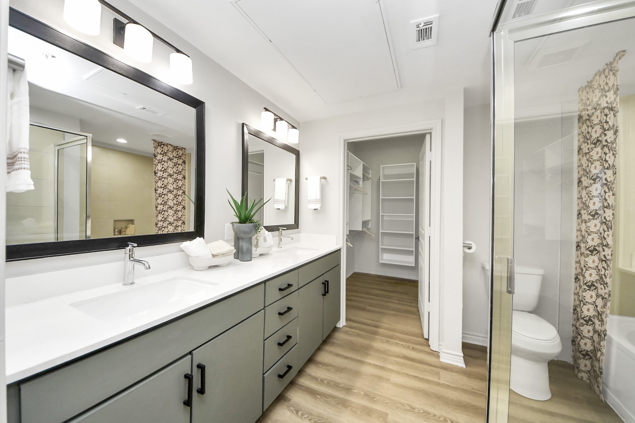 3003 Memorial Court, Unit 2434 Houston, TX 77007 - Photo 16 of 34 a bathroom with a double vanity sink and a mirror