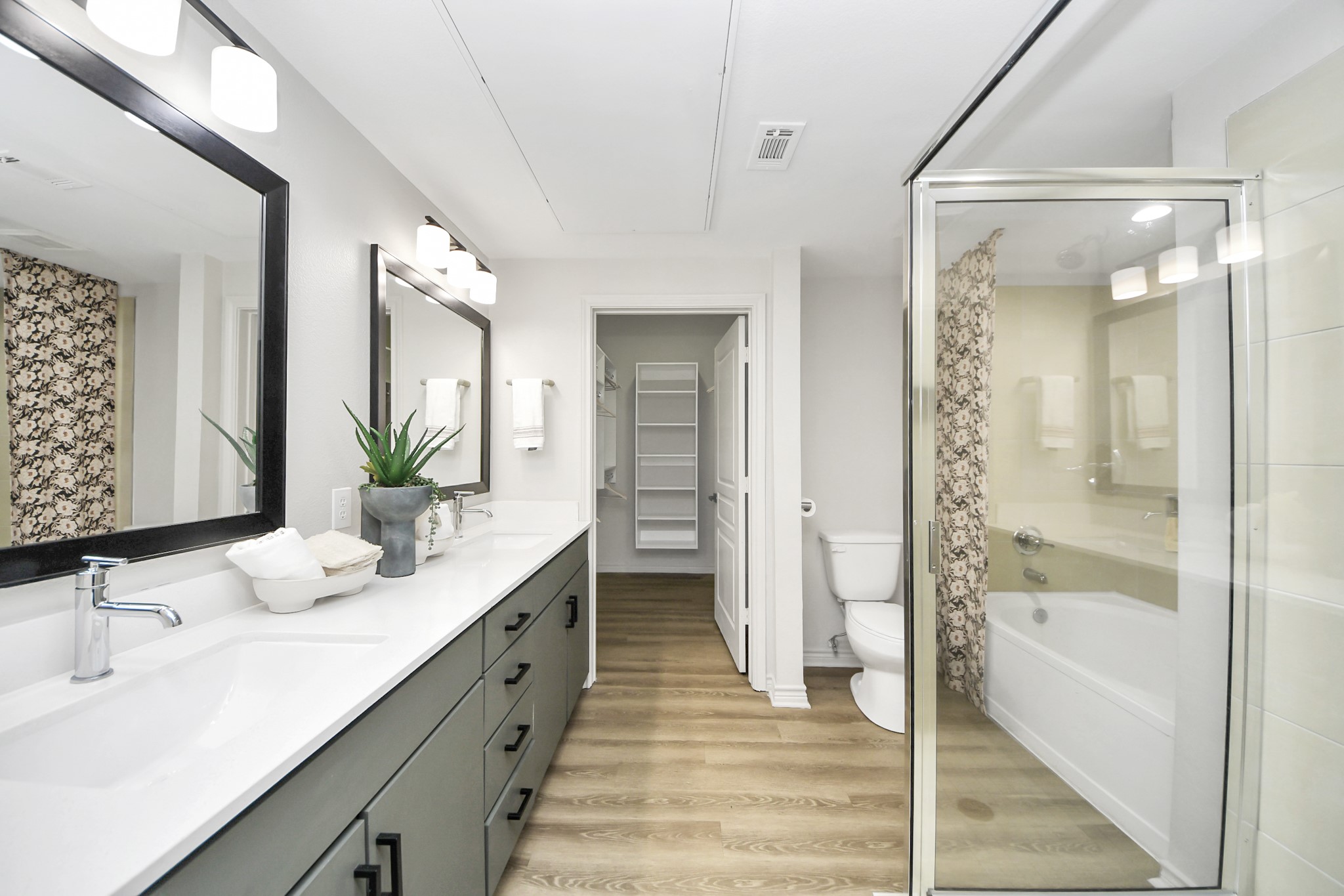3003 Memorial Court, Unit 2434 Houston, TX 77007 - Photo 17 of 34 a bathroom with a double vanity sink mirror and shower