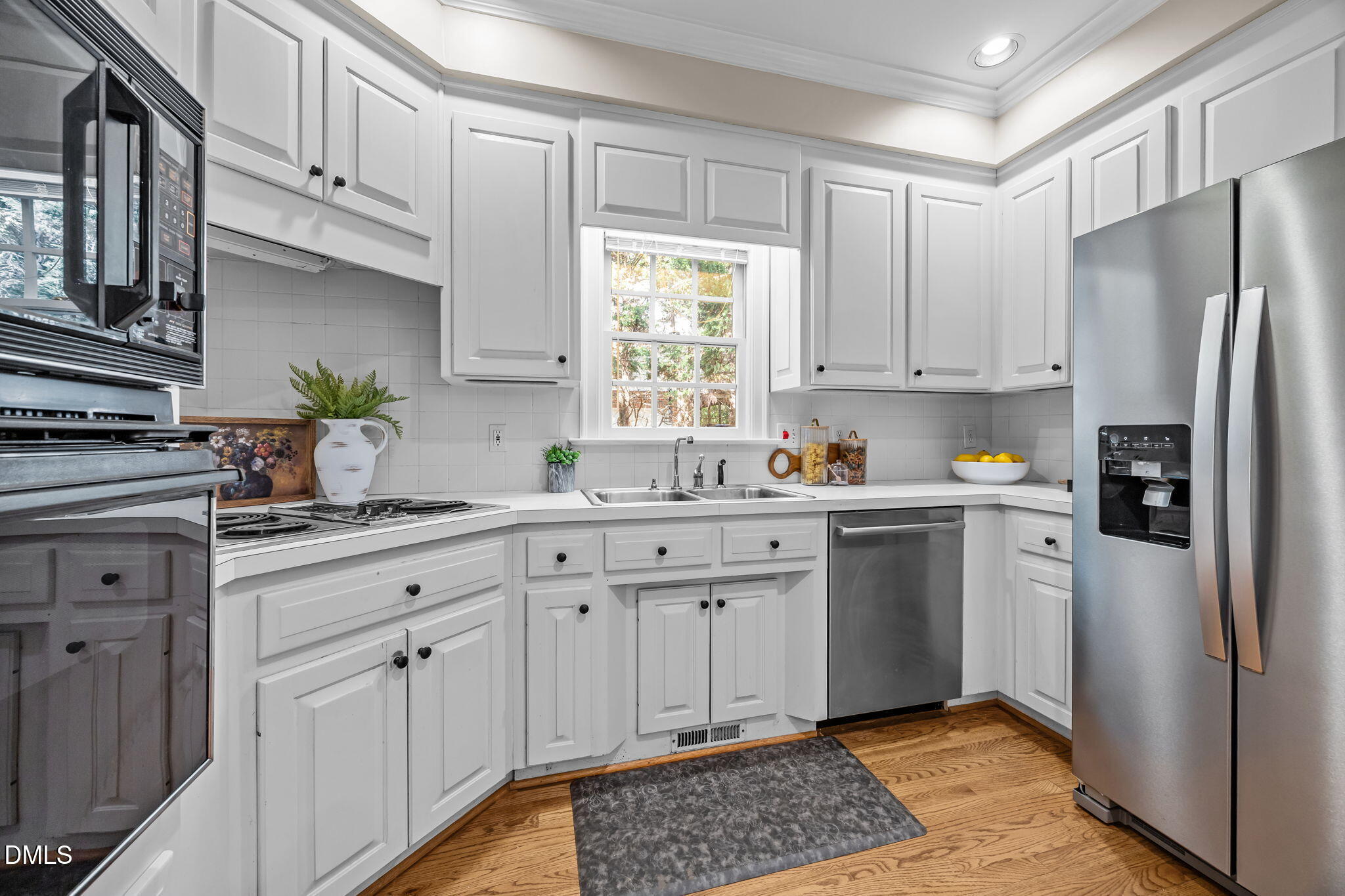 1535 Crenshaw Point Wake Forest, NC 27587 - Photo 11 of 27 a kitchen with stainless steel appliances granite countertop a refrigerator sink and white cabinets
