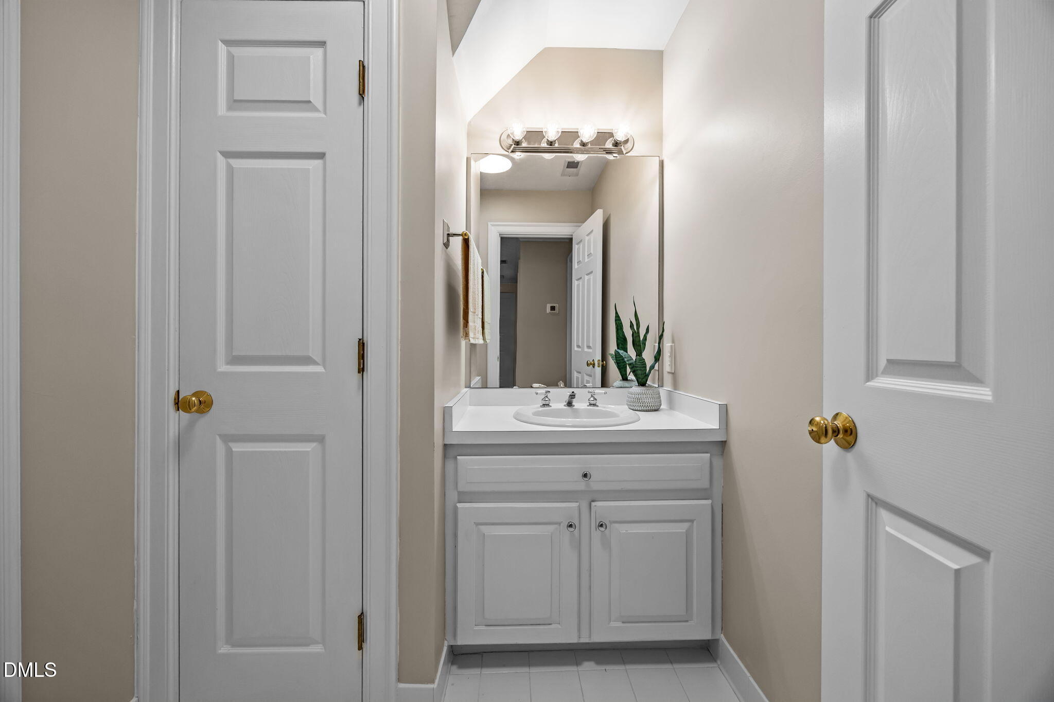 1535 Crenshaw Point Wake Forest, NC 27587 - Photo 20 of 27 a bathroom with a light fixture a mirror and a sink