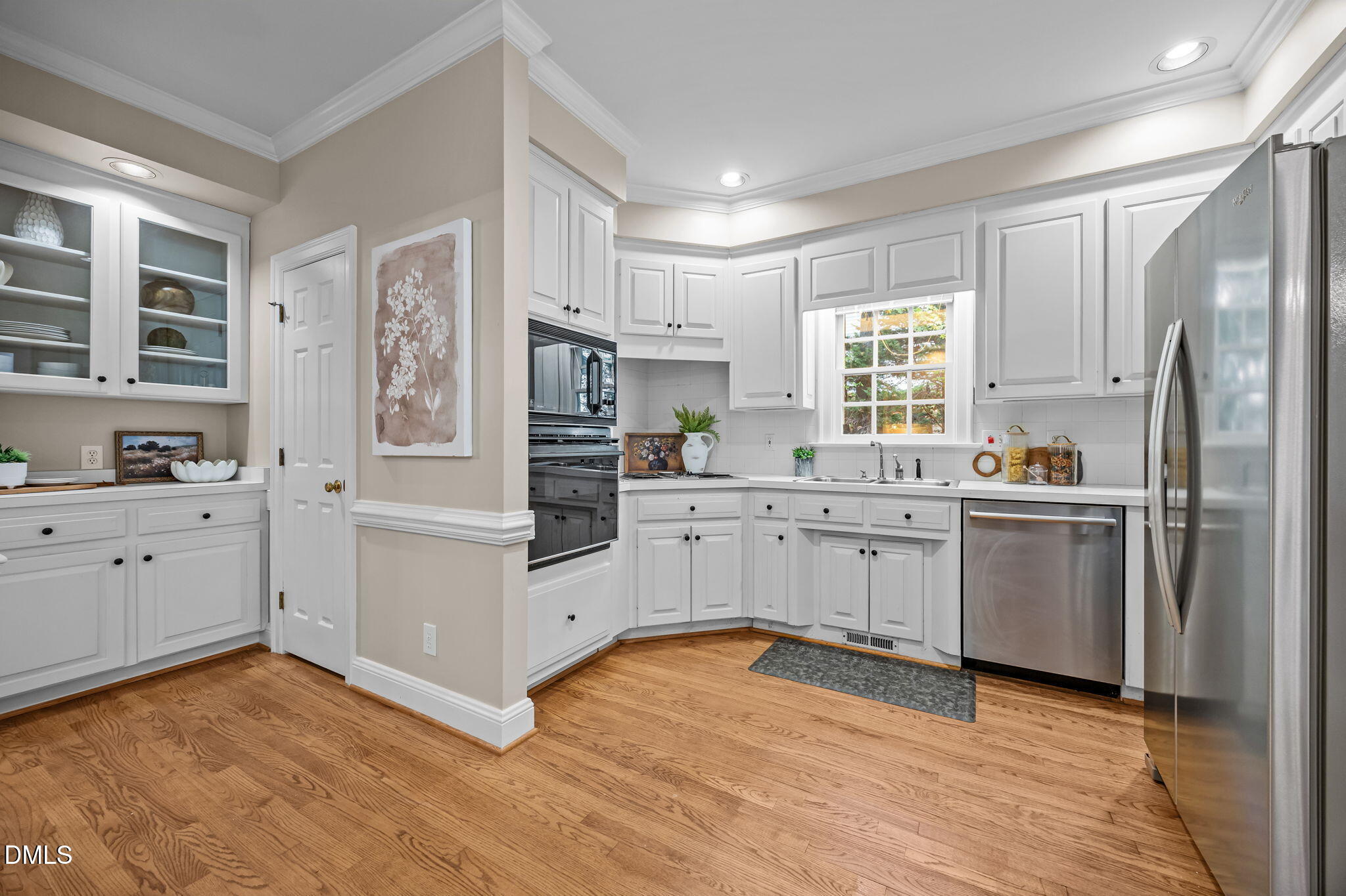 1535 Crenshaw Point Wake Forest, NC 27587 - Photo 10 of 27 a kitchen with white cabinets and white appliances