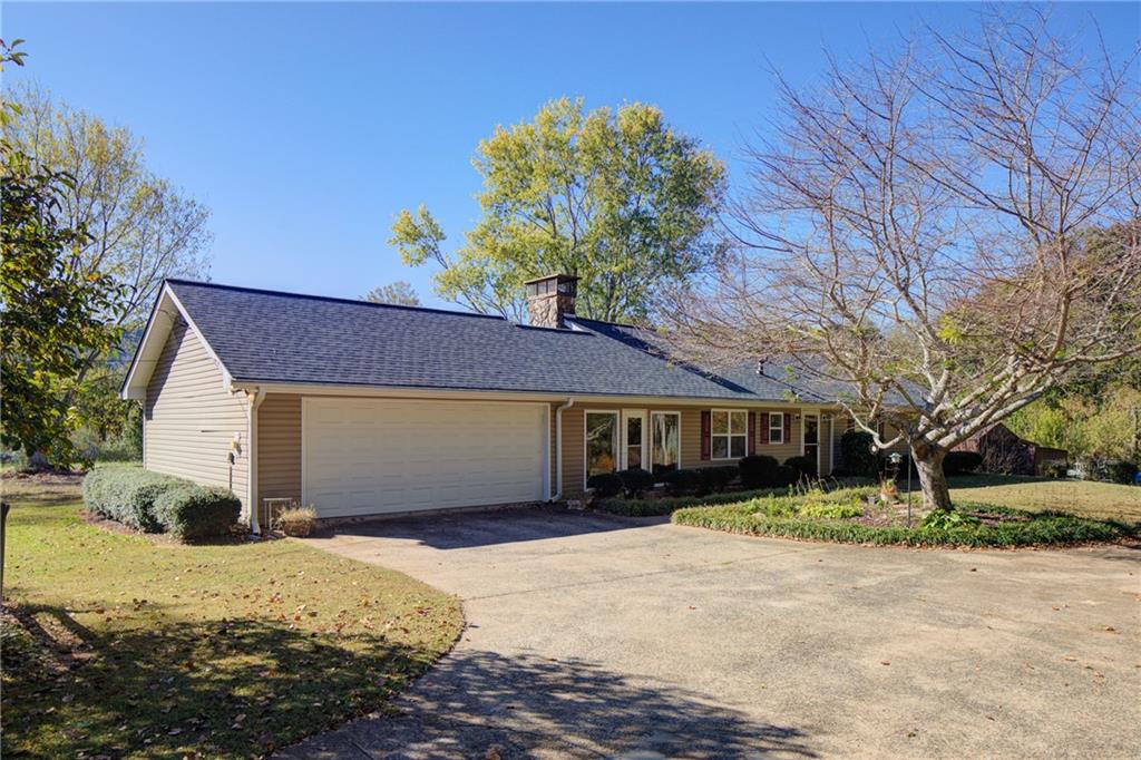 4920 McCoy Circle Cumming, GA 30040 - Photo 27 of 31 a front view of a house with a yard and garage
