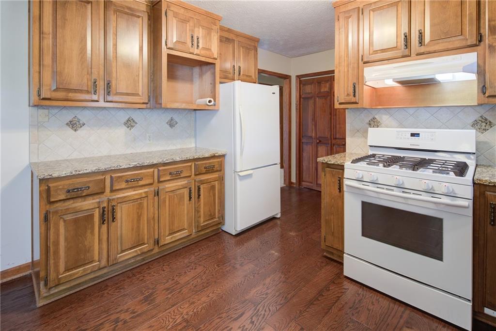4920 McCoy Circle Cumming, GA 30040 - Photo 6 of 31 a kitchen with cabinets and steel stainless steel appliances