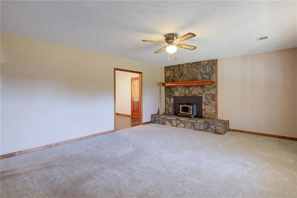 4920 McCoy Circle Cumming, GA 30040 - Photo 8 of 31 a view of an empty room with a fireplace