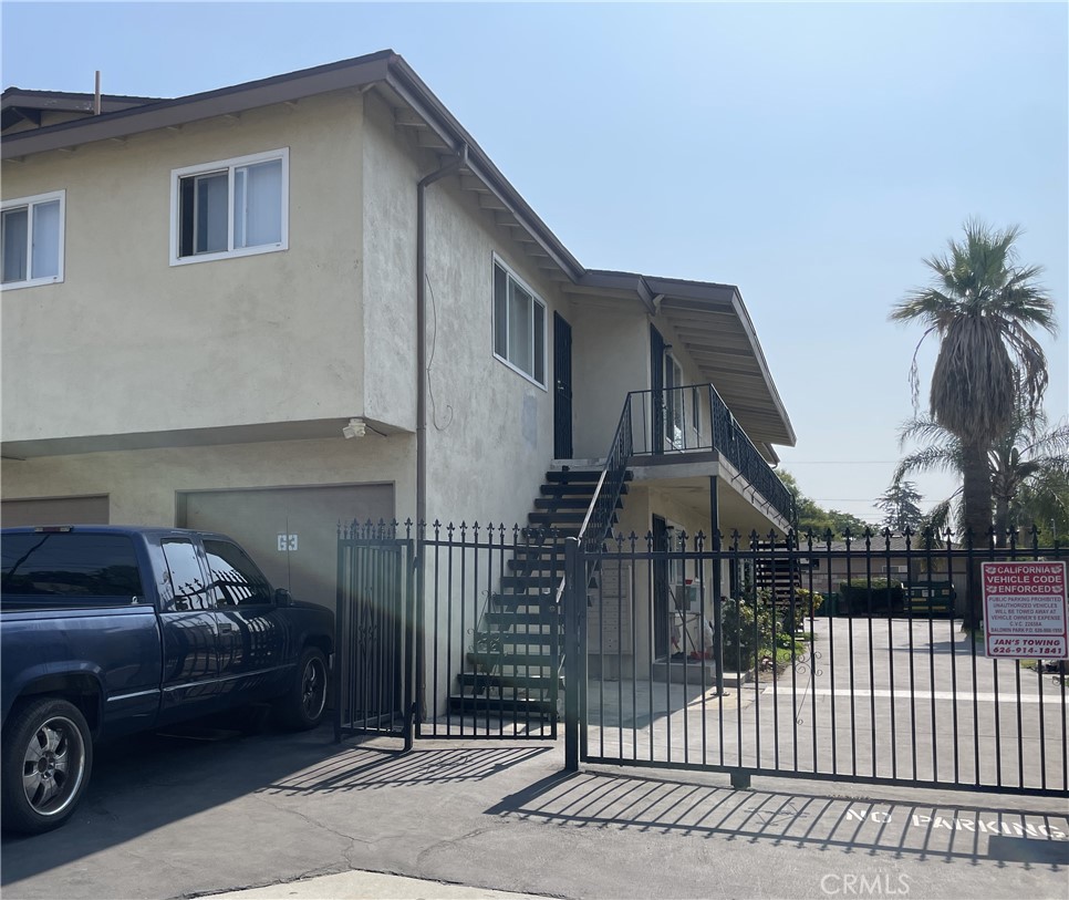 4920 Maine Avenue, Unit M Baldwin Park, CA 91706 - Photo 14 of 17 a view of a white house and a car parked front of it