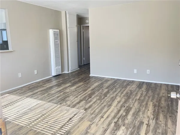 a view of a room with wooden floor and bathroom