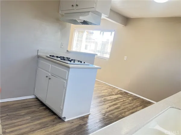 a kitchen with a cabinets and wooden floor