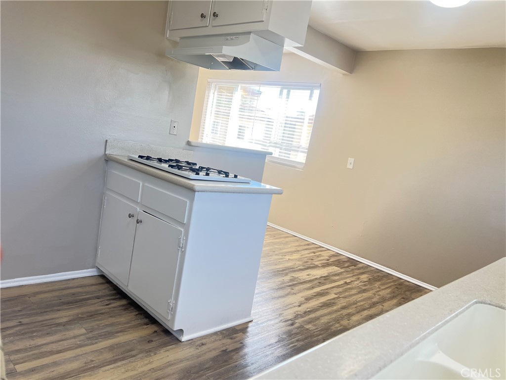 4920 Maine Avenue, Unit M Baldwin Park, CA 91706 - Photo 6 of 17 a kitchen with wooden floor and window