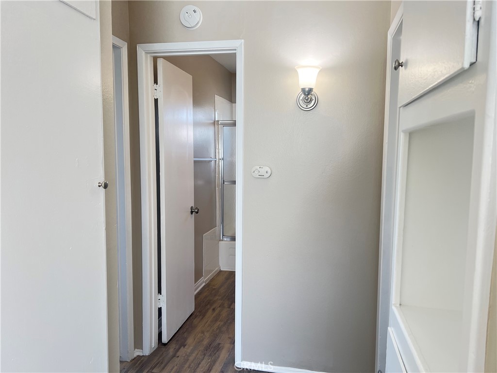 4920 Maine Avenue, Unit M Baldwin Park, CA 91706 - Photo 8 of 17 a view of a hallway with a wooden door