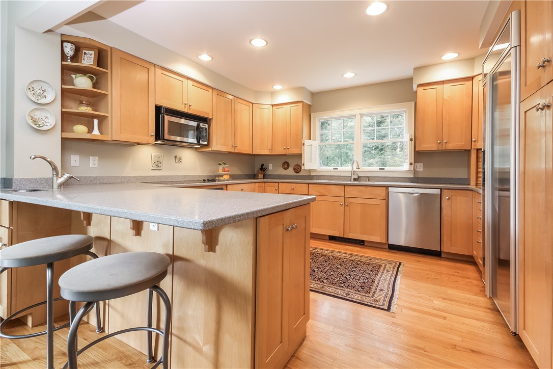 52 Verdi Road Westerly, RI 02891 - Photo 11 of 40 Modern kitchen with maple cabinets, Corian counter tops and stainless steel appliances.