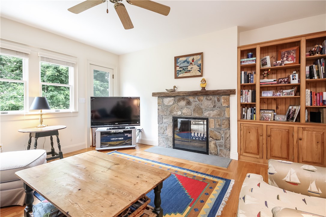 52 Verdi Road Westerly, RI 02891 - Photo 16 of 40 Den/media room with built-in bookshelves and stone fireplace.