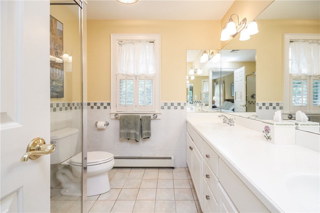 52 Verdi Road Westerly, RI 02891 - Photo 20 of 40 Master bathroom with Corain double-sink vanity and tile and glass shower.